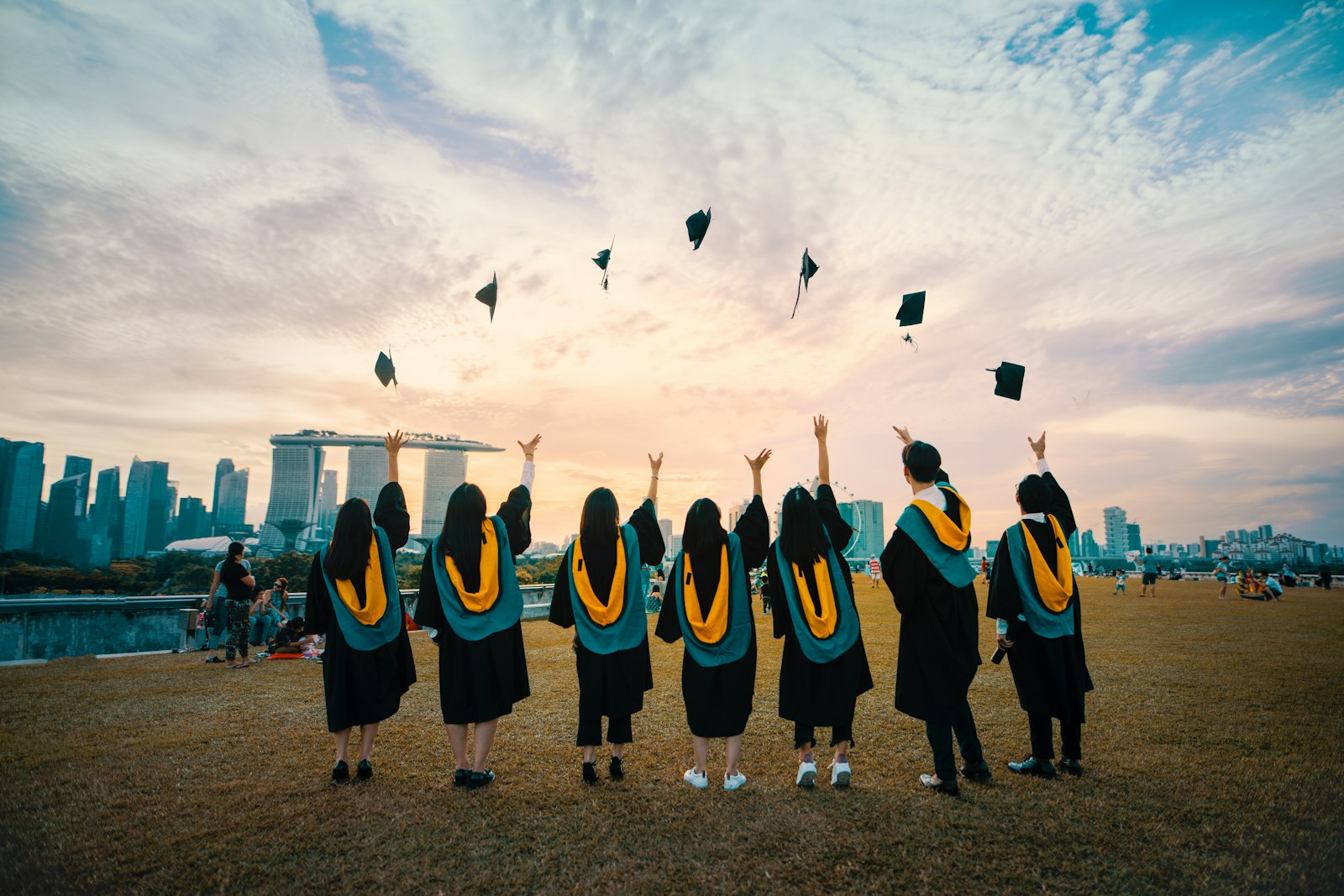 Graduates celebrating at sunset after completing their studies abroad
